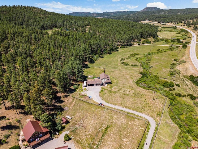 aerial view featuring a mountain view and a wooded view