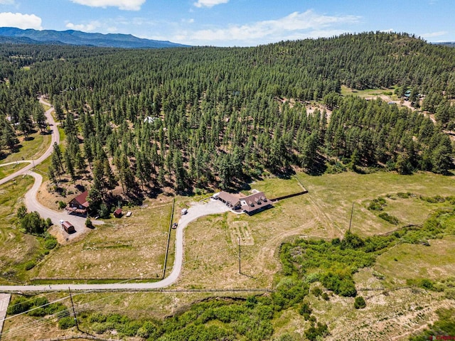 aerial view with a mountain view and a view of trees