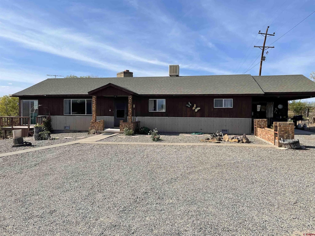 view of front of home featuring crawl space and roof with shingles