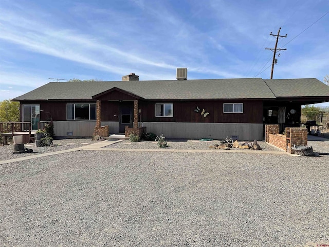 view of front of home featuring crawl space and roof with shingles