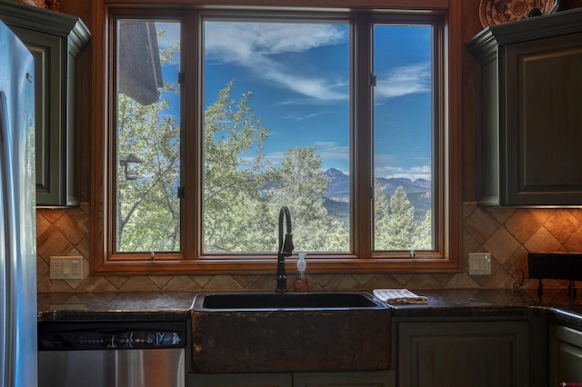 kitchen featuring backsplash, sink, stainless steel appliances, and plenty of natural light