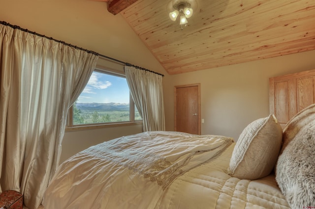 bedroom with a mountain view, lofted ceiling with beams, and wood ceiling