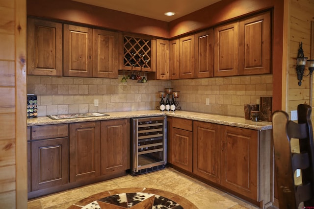 kitchen with decorative backsplash, light stone countertops, and wine cooler