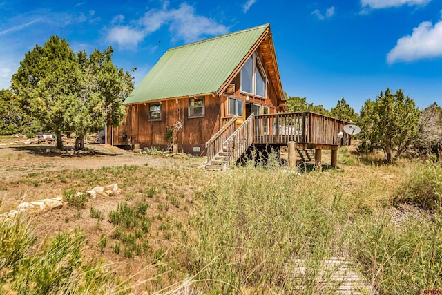 rear view of property featuring a deck