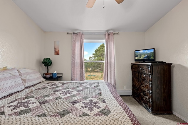 carpeted bedroom with ceiling fan and a baseboard radiator