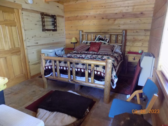 bedroom with tile flooring, wooden walls, and radiator