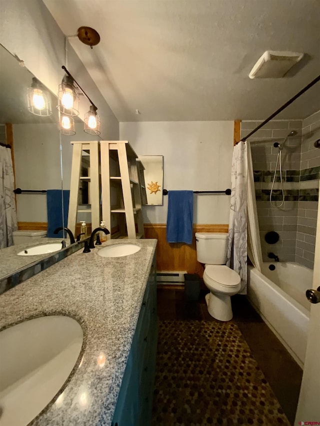 bathroom featuring shower / bath combo, a sink, and double vanity