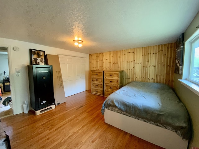 bedroom featuring a textured ceiling and wood finished floors