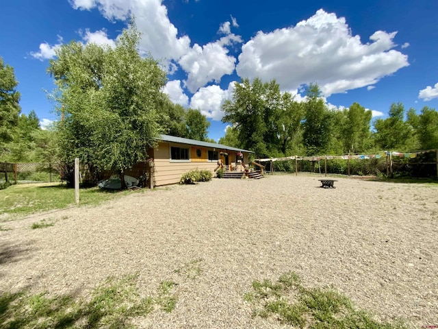 view of front facade featuring an outdoor fire pit