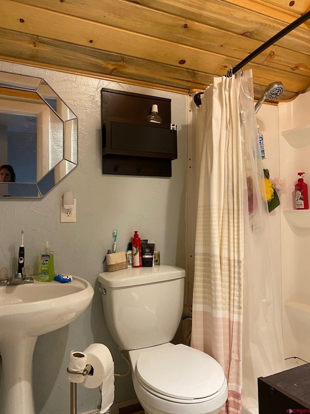 bathroom with toilet and wood ceiling