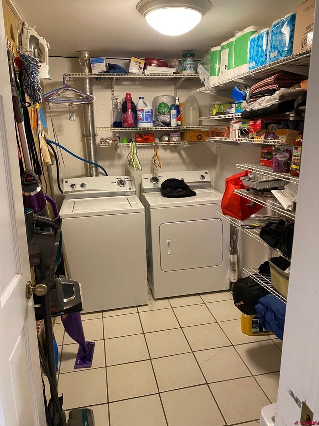 washroom featuring separate washer and dryer and light tile flooring