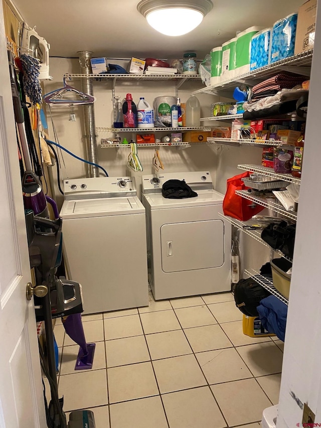 laundry room featuring laundry area, independent washer and dryer, and tile patterned floors