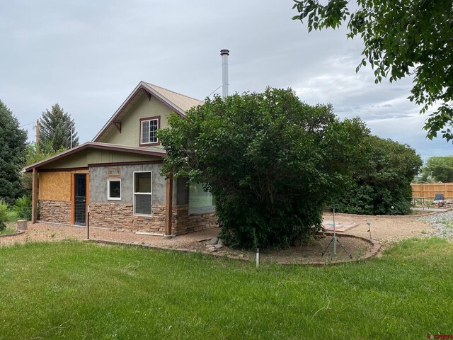 view of side of property with a lawn