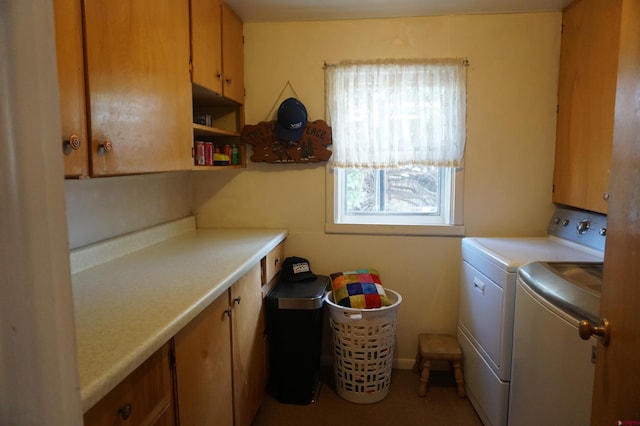 washroom with cabinets and washer and clothes dryer