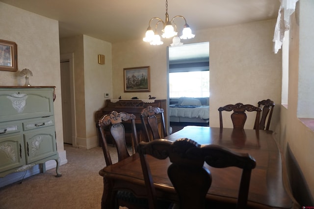 carpeted dining area with a notable chandelier