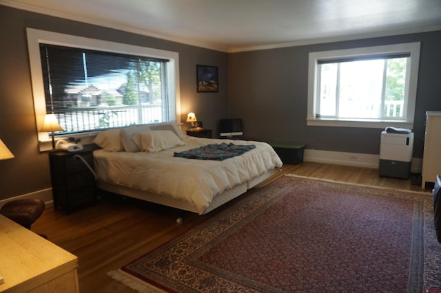 bedroom with ornamental molding and hardwood / wood-style floors