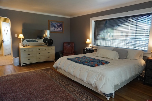 bedroom featuring crown molding and hardwood / wood-style flooring