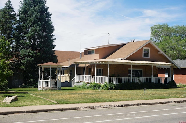 view of front of house featuring a front yard and covered porch