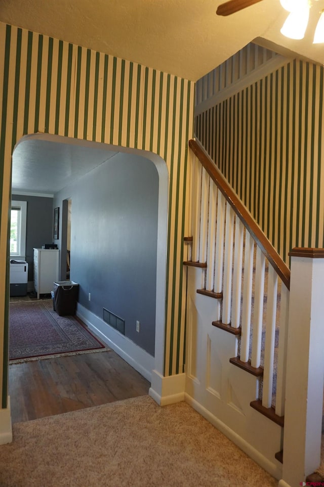 stairs with ceiling fan and hardwood / wood-style floors