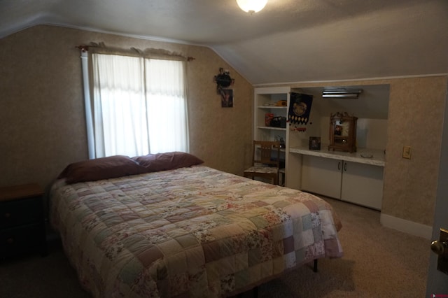 bedroom with lofted ceiling and carpet flooring