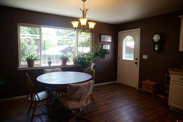 dining space with a notable chandelier, dark hardwood / wood-style flooring, and plenty of natural light