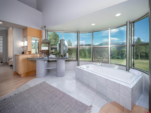 bathroom featuring tile patterned floors and tiled tub