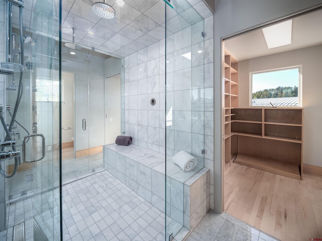 bathroom with a shower with door