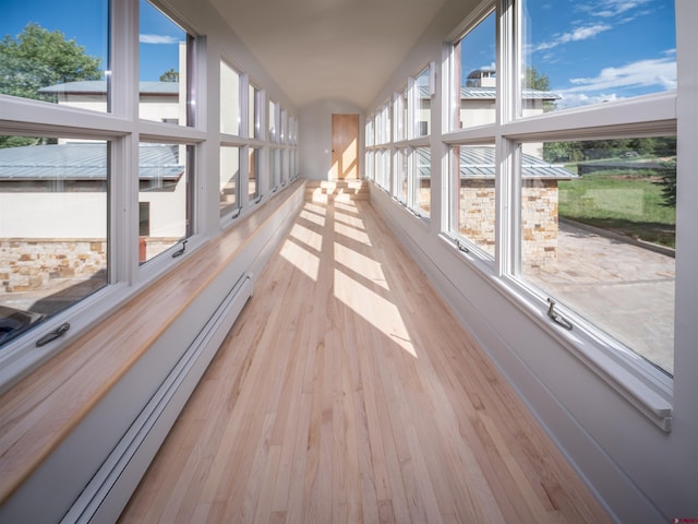 unfurnished sunroom featuring baseboard heating