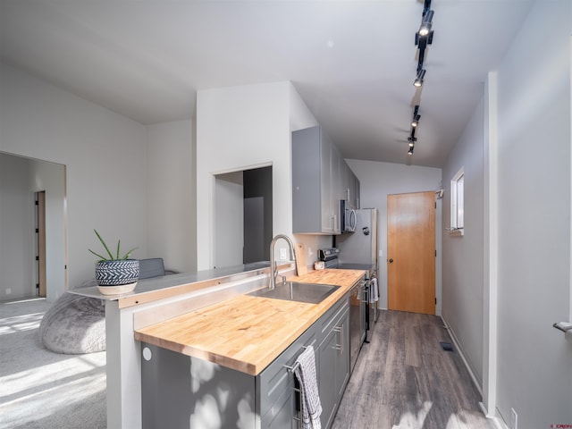 kitchen featuring sink, gray cabinets, wooden counters, range, and dark hardwood / wood-style flooring