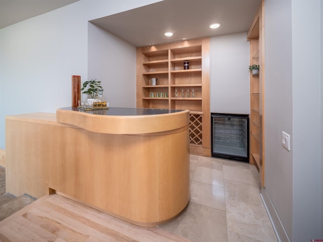 bar featuring light brown cabinetry