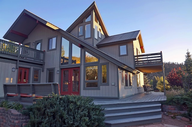 back of house with a balcony, metal roof, and french doors