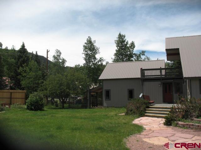 view of yard with a balcony