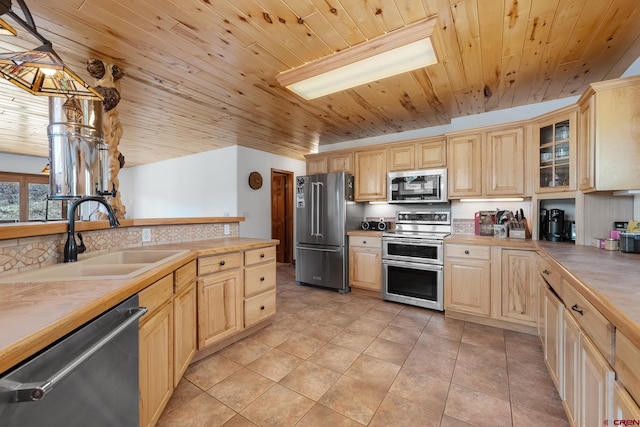 kitchen with light brown cabinets, pendant lighting, wood ceiling, light tile floors, and appliances with stainless steel finishes