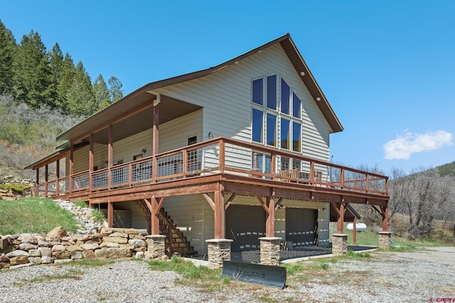 26 Severn Peak Rd, Bayfield, CO 81122 - view of front of home featuring a deck, an attached garage, stairway, and driveway