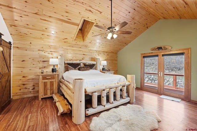 26 Severn Peak Rd, Bayfield, CO 81122 - bedroom with wood walls, vaulted ceiling, wood ceiling, wood finished floors, and a barn door