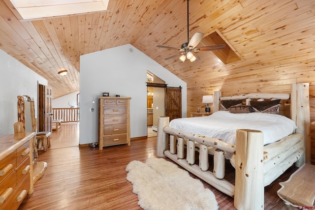 bedroom with a skylight, wood walls, a barn door, wood ceiling, and wood-type flooring