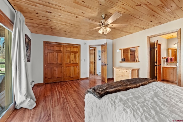 bedroom featuring ceiling fan, hardwood / wood-style floors, ensuite bath, and wooden ceiling