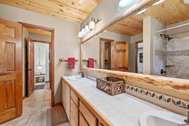 26 Severn Peak Rd, Bayfield, CO 81122 - bathroom with wood ceiling, double vanity, a tile shower, and stone tile floors