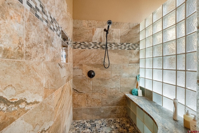 bathroom with a tile shower