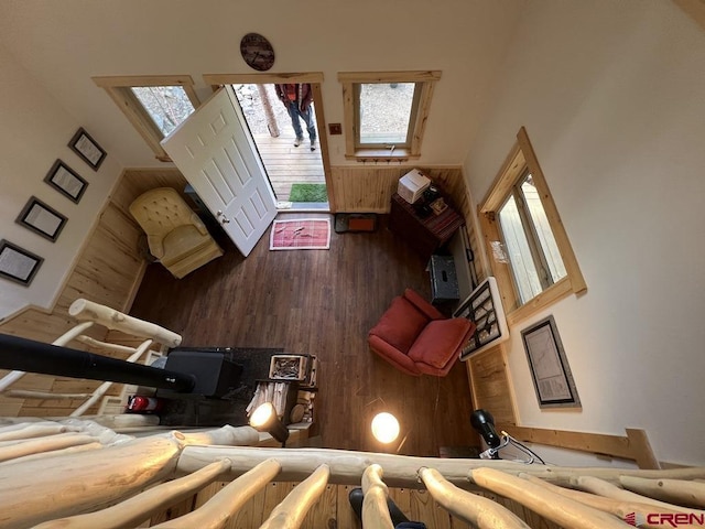 living room featuring a high ceiling and wooden walls