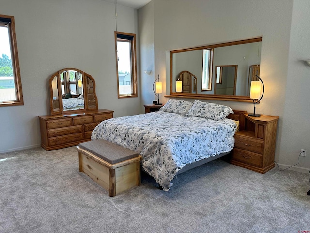 carpeted bedroom featuring a high ceiling