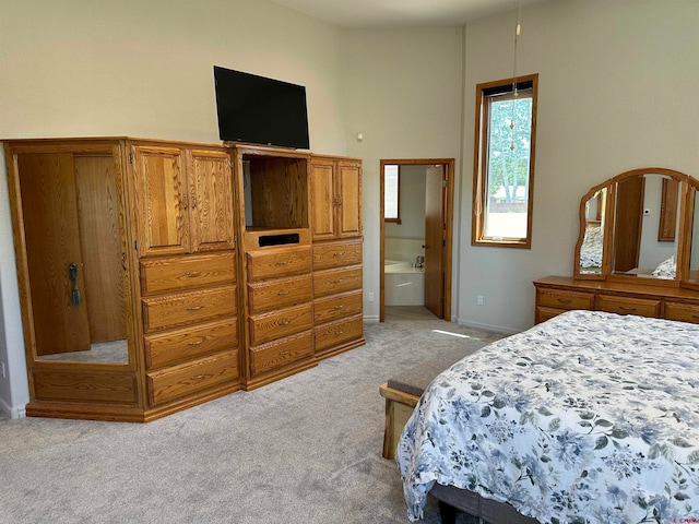 carpeted bedroom with connected bathroom