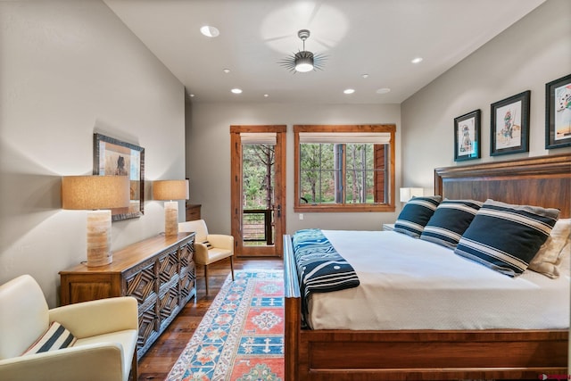 bedroom with access to exterior and dark wood-type flooring