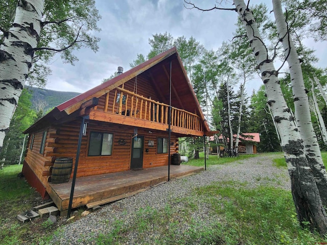 view of home's exterior featuring a balcony and a deck