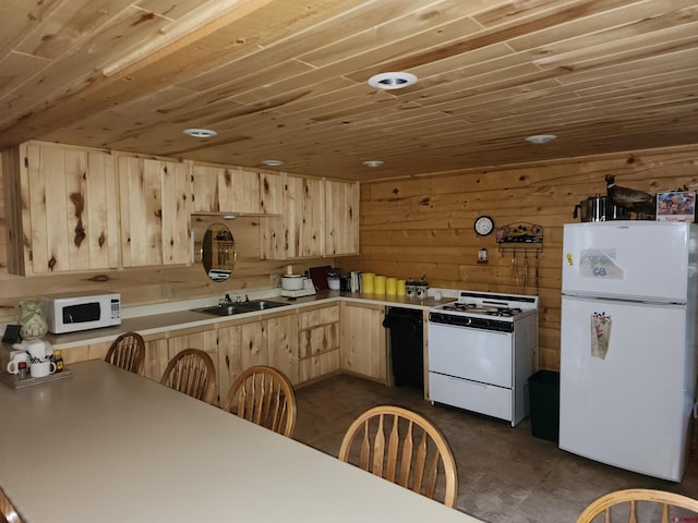 kitchen featuring light brown cabinetry, wooden ceiling, white appliances, sink, and wood walls