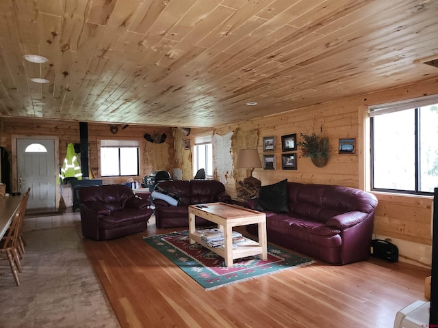 living room with hardwood / wood-style flooring, wood ceiling, and wooden walls