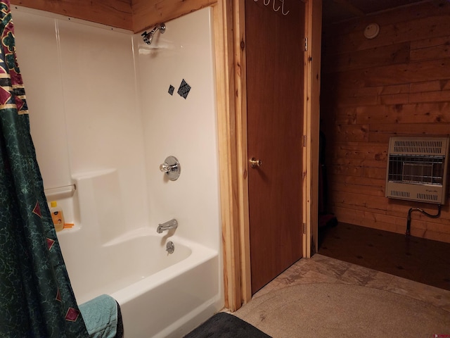 bathroom with shower / bath combo with shower curtain, heating unit, and wooden walls