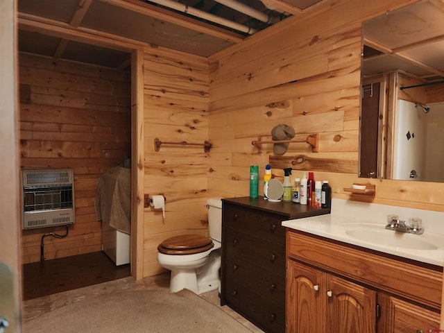 bathroom featuring vanity, wood walls, heating unit, and toilet