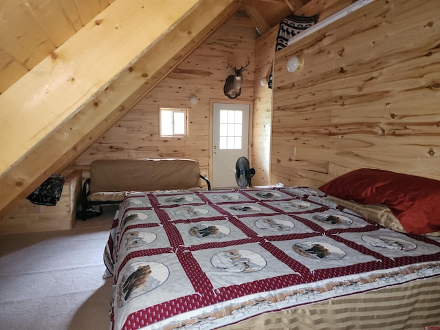 carpeted bedroom featuring wooden walls and lofted ceiling