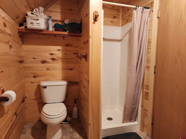 bathroom featuring curtained shower, tile flooring, wooden walls, and toilet